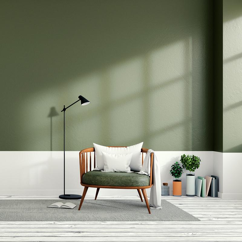 Grüne Wand mit weißem Boden und Sessel